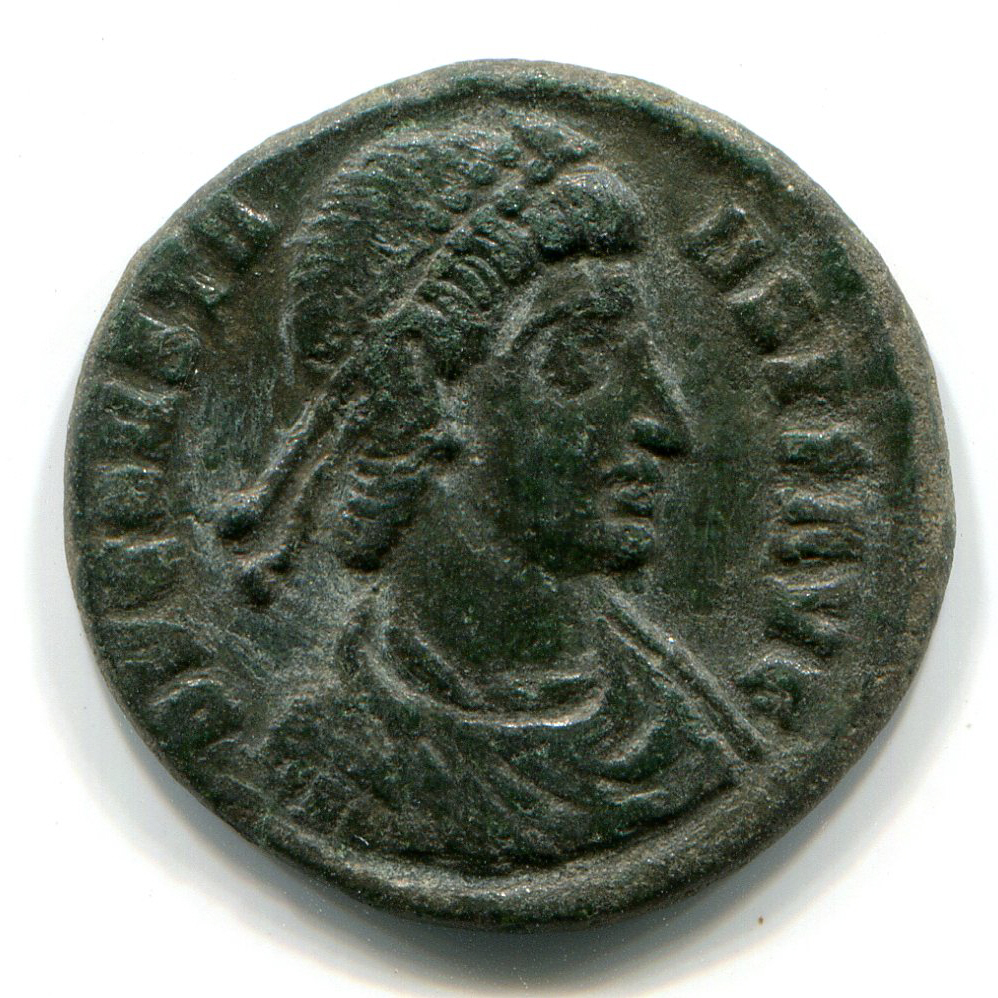 Roman coin with a bust of the Emperor Constans facing right and an inelligible inscription. Dark green patina.